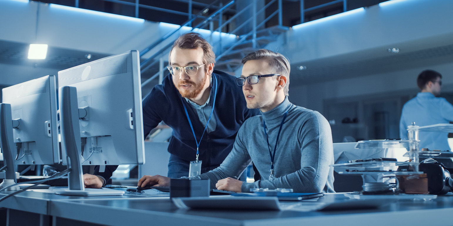 2 workers looking at a computer screen