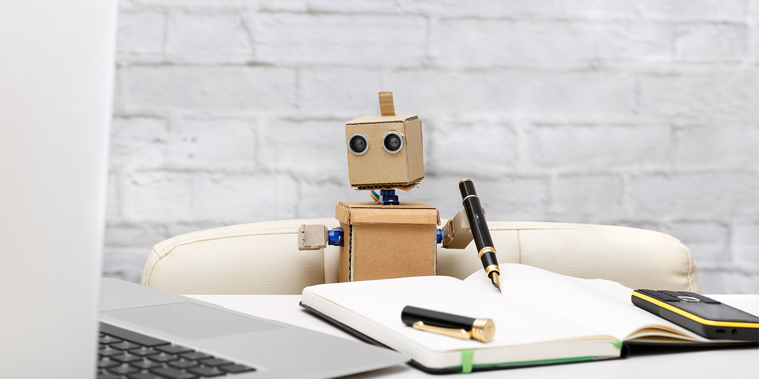 person made out of boxes sitting at a desk