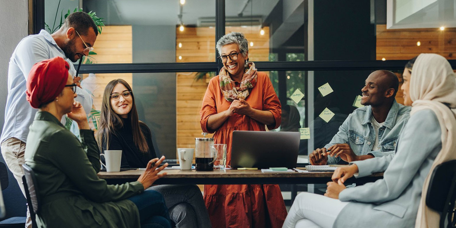 a group of people in an office having coffee