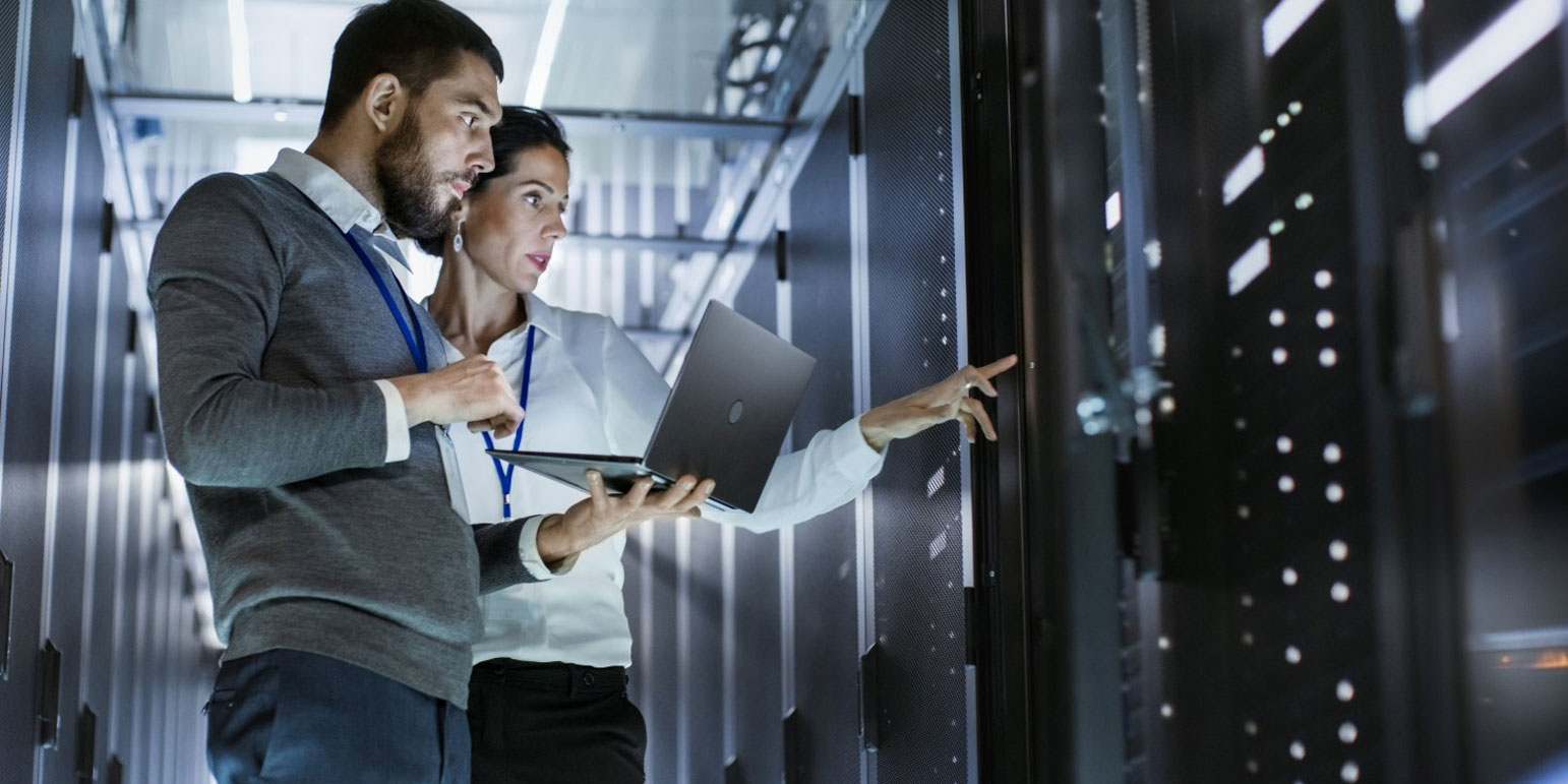 two workers looking at a server